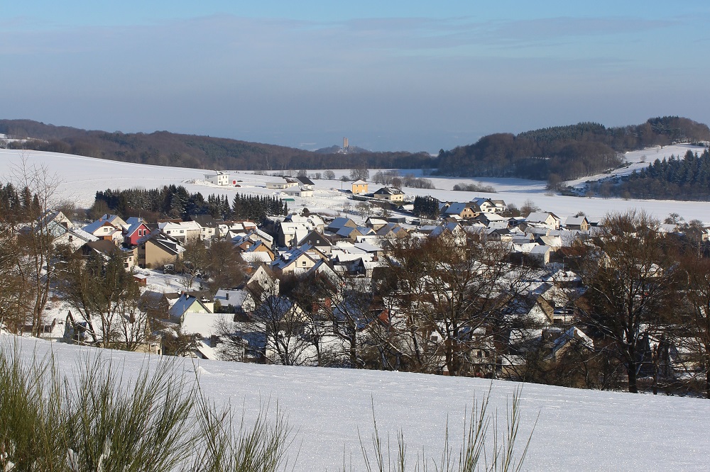 Mit Fernblick in Richtung Rheintal: die Ortsgemeinde Spessart – im Hintergrund die Burg Ohlbrück. / © Frank Klapperich