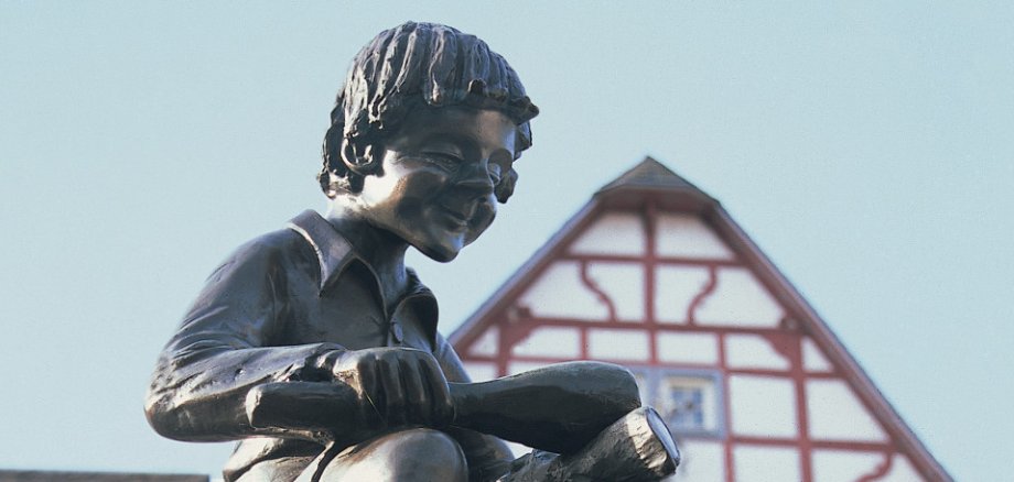 Das Treiser Wahrzeichen auf dem Marktplatz – die markante Brunnenfigur des „Heckedotz“. Das kleine Männlein auf der Spitze des Brunnens erinnert an die Vergangenheit des Dorfes. / Foto: Bruno L. Klamm, Mannheim